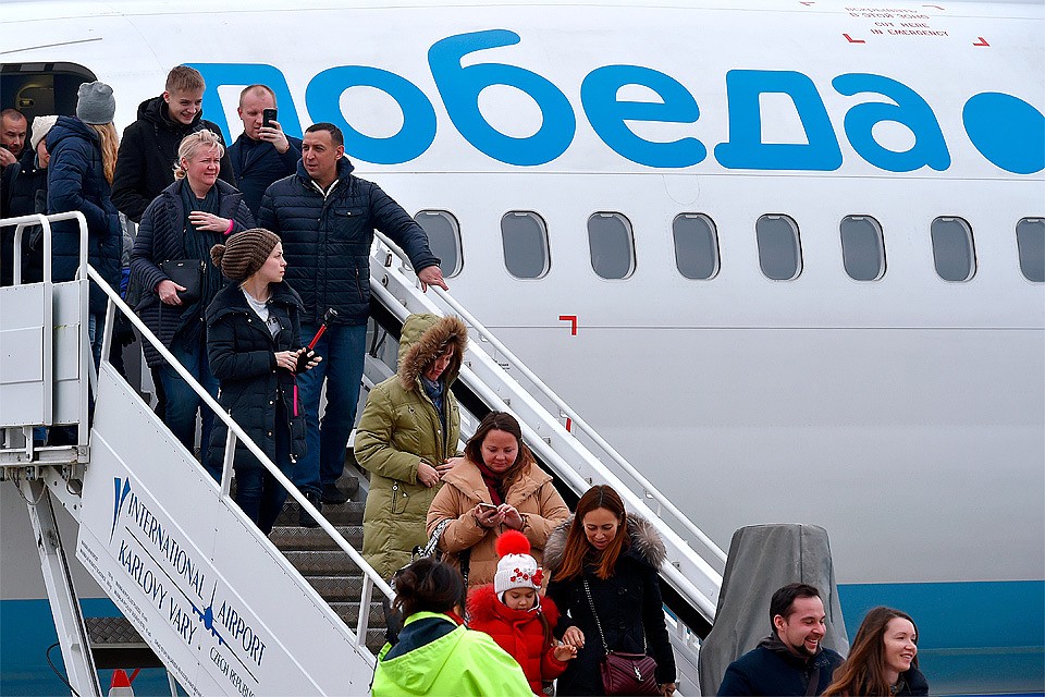 Пассажиры авиакомпании "Победа" покидают самолет.