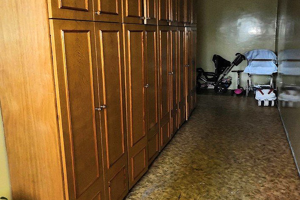 Классический вариант захламленной лестничной клетки с лидерами "антирейтинга": старый шкаф и пара колясок... Фото: Мосжилинспекция