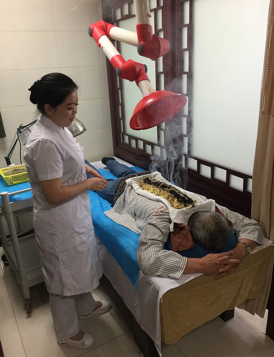 В новой современной больнице есть место и для традиционной народной китайской медицины. Например, для прижигания чесноком. Говорят, очень эффективно для всяких там остеохондрозов. Но людям с тонким обонянием во время процедуры лучше рядом не стоять Фото: Александр ГРИШИН