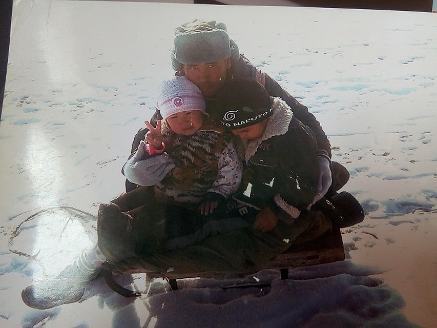 The daughter remembers the father took them sledding in the steppe.